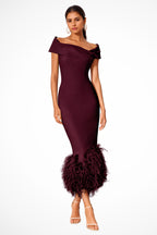 Model walking in off shoulder feather dress