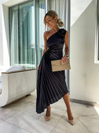 Model in dress, side profile showing pleated skirt drape