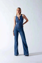 Women's mid-blue denim sleeveless jumpsuit with zip-front, displayed on model