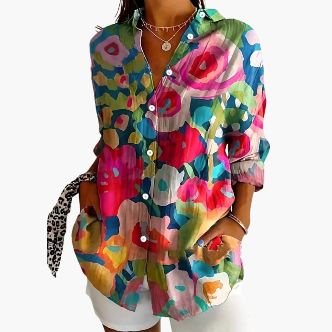 Detail shot of button-front closure and collared neckline on abstract print blouse
