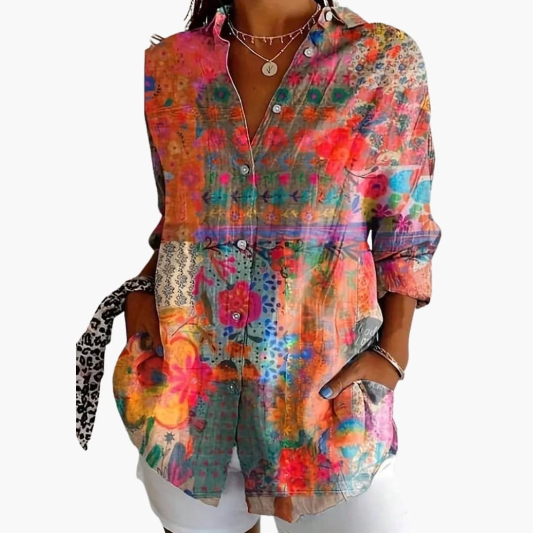 Model wearing abstract blouse, front view with collared neckline and button closure