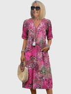 Model showcasing dress from back, V-neckline detail visible