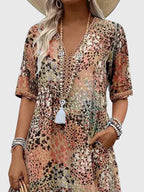 Model in relaxed stance wearing floral dress outdoors