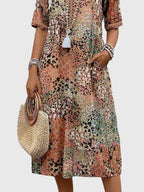 Floral dress hem and silhouette, standing pose detail