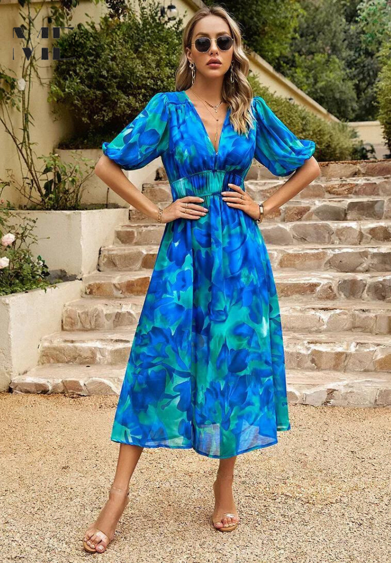 Model wearing dress, posed against neutral background