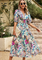 Back view of woman wearing floral maxi dress with puff sleeves