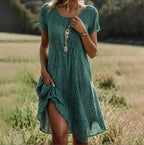 Model wearing floral midi dress in standing pose, showcasing relaxed silhouette and length