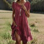 Back view of floral midi dress highlighting drape and flowing fabric design