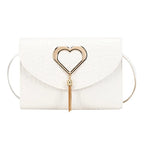 Heart clasp detail in silver tone with dangling tassel