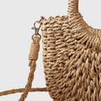 Circular woven handle detail on natural straw bag