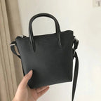 Bag worn crossbody on model, side profile shot
