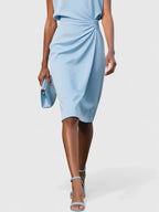 Model in navy midi dress, back view showing keyhole neckline