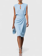 Close-up detail of ruched waist and draped fabric on dress