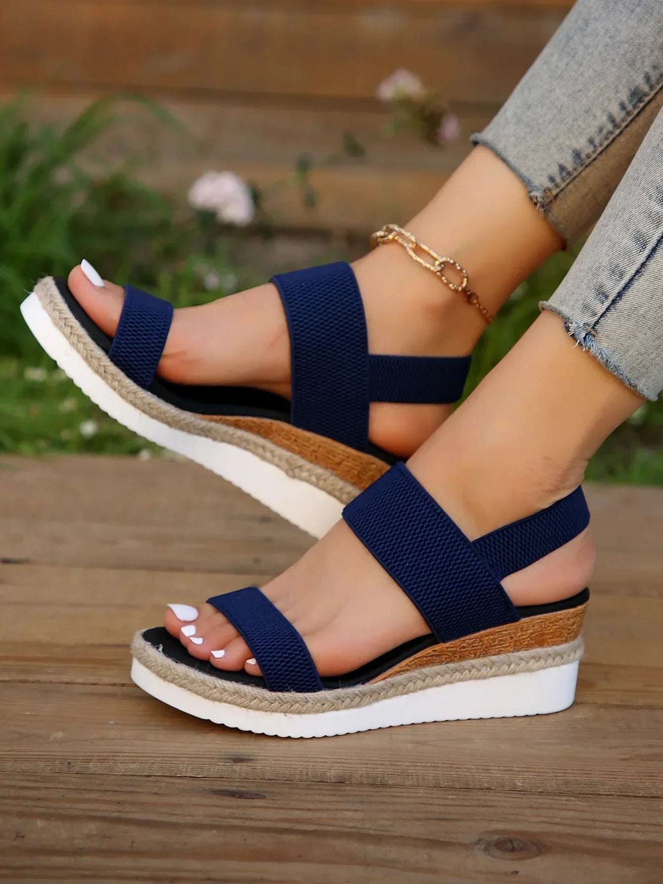 Model wearing sandals, seated pose highlighting comfort fit