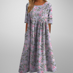 Model in floral dress, relaxed pose showing fit and drape