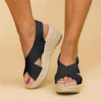 Woman wearing cross strap wedge sandals, standing pose