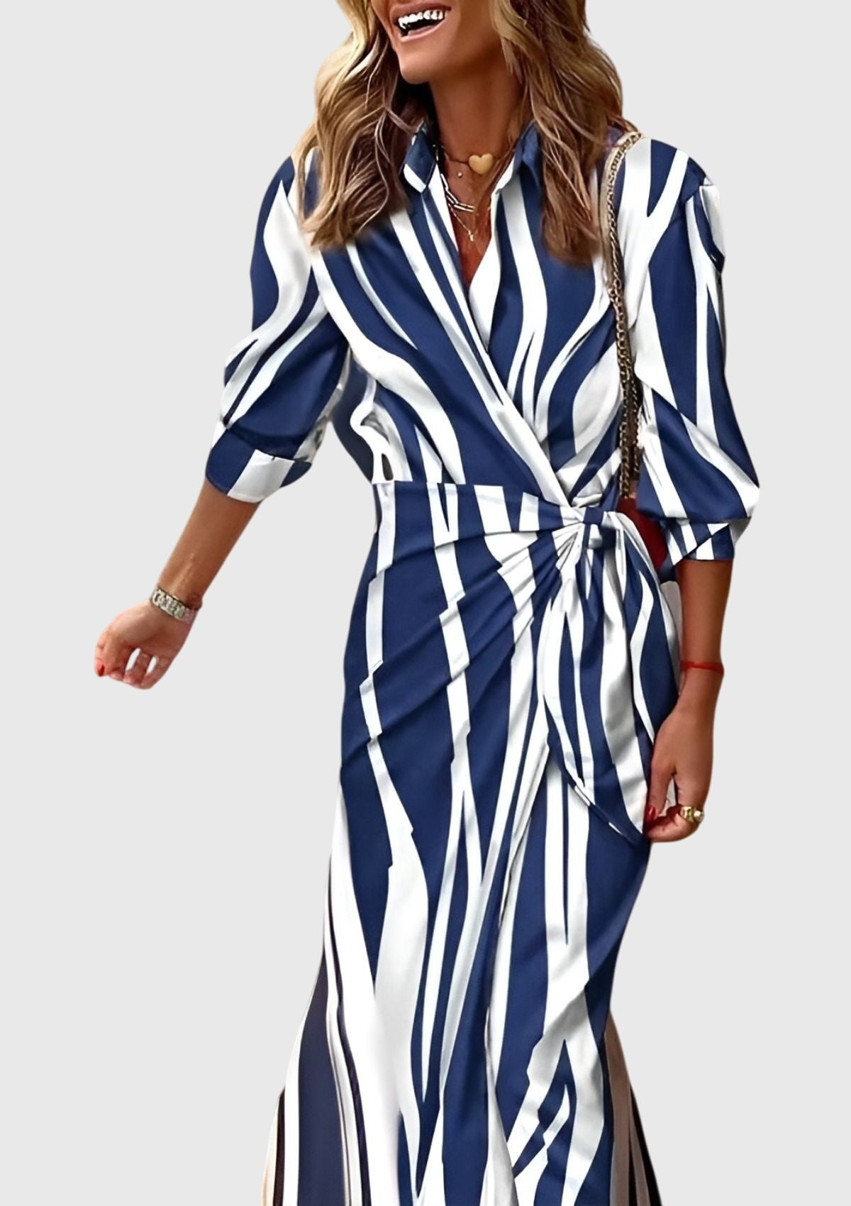 Model seated wearing geometric wrap maxi dress