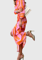 Tie belt detail cinching waist of geometric wrap dress