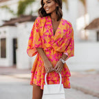 Women's orange and pink floral mini dress with ruffle hem, front view