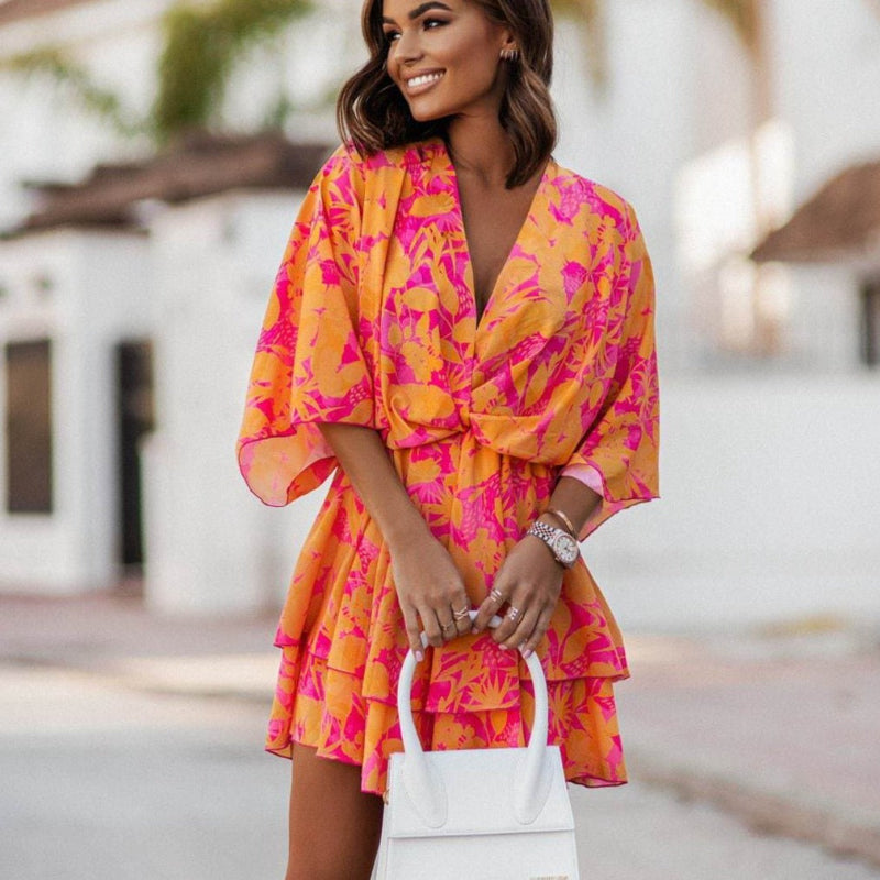 Women's orange and pink floral mini dress with ruffle hem, front view