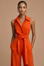 Close-up of collared neckline and button-through bodice on orange jumpsuit