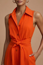 Rear view of sleeveless orange jumpsuit highlighting back seaming and wide leg cut