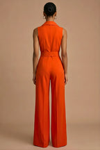 Full-length view of woman wearing orange jumpsuit in relaxed standing pose