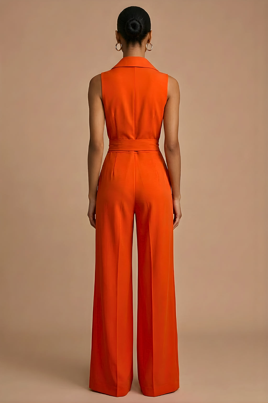 Full-length view of woman wearing orange jumpsuit in relaxed standing pose