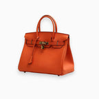Orange textured leather structured tote bag with gold hardware, front view
