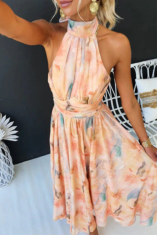 Halter neckline and tie fastening detail on watercolour dress