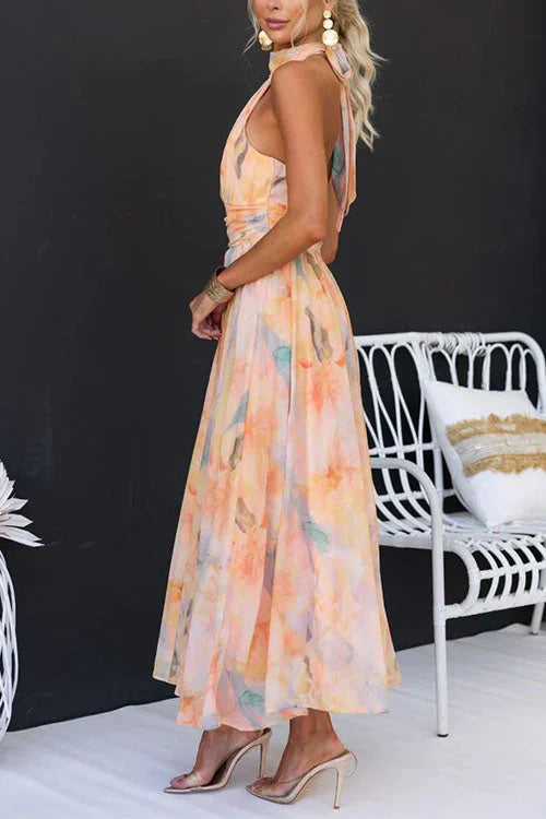 Model in peach watercolour maxi dress, rear view showing open back design
