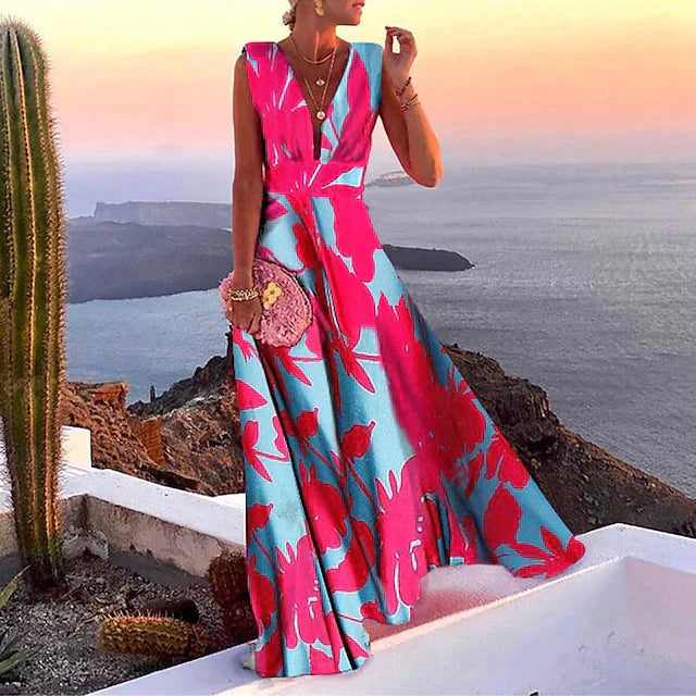 Woman wearing pink and blue floral sleeveless maxi dress, front view