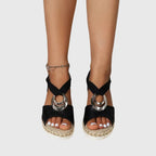 Woman wearing espadrille wedge sandals standing outdoors