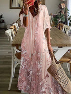Model wearing pink floral maxi dress, side pose showing drape and silhouette