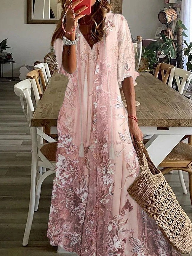 Model wearing pink floral maxi dress, side pose showing drape and silhouette
