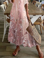 Close-up detail of delicate pink floral lace print on dress fabric