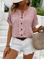 Women's pink floral button-up blouse, front view on white background