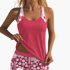 Women's pink floral racerback tankini top displayed flat against white background
