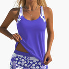 Model wearing floral tankini top, front-facing pose showing scoop neckline