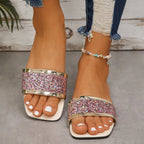Model wearing glitter sandals, standing pose from the side