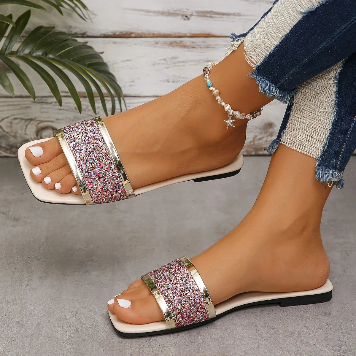 Women's flat sandal with pink glitter panel and gold metallic trim, front view