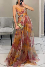 Model seated in floral maxi dress showing how fabric drapes when sitting