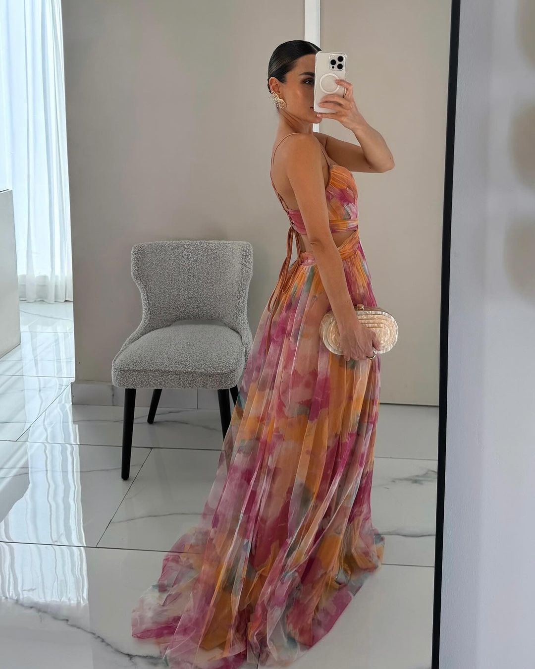 Side profile of model in floral wrap maxi dress, demonstrating draping fabric
