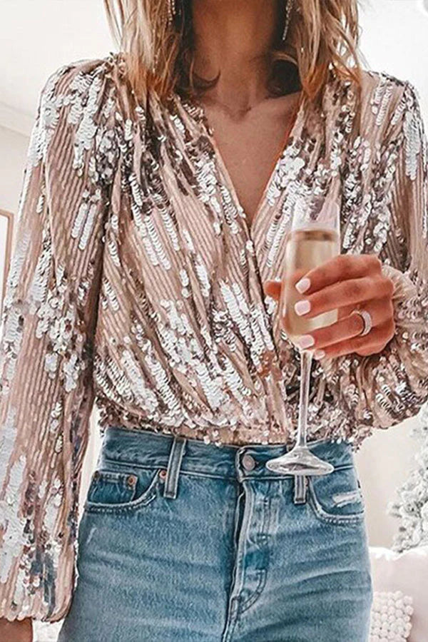 Women's pink sequin wrap top with long sleeves and V-neckline, full front view