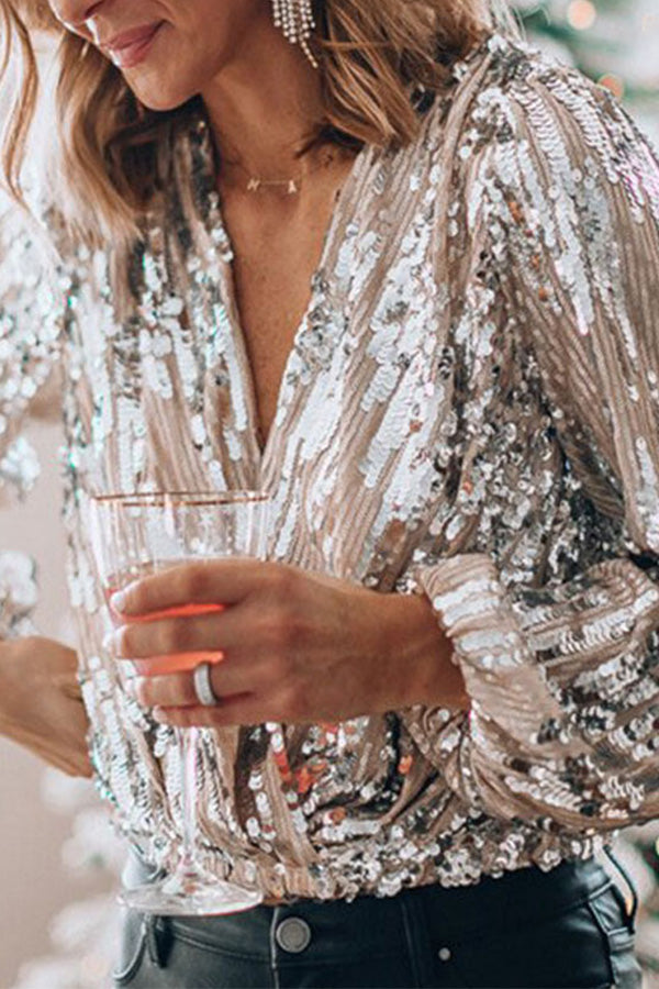 Model wearing pink sequin wrap top, side profile showing wrap silhouette and waist cinch