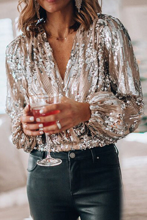 Close-up detail of all-over sequin embellishment on pink wrap top fabric