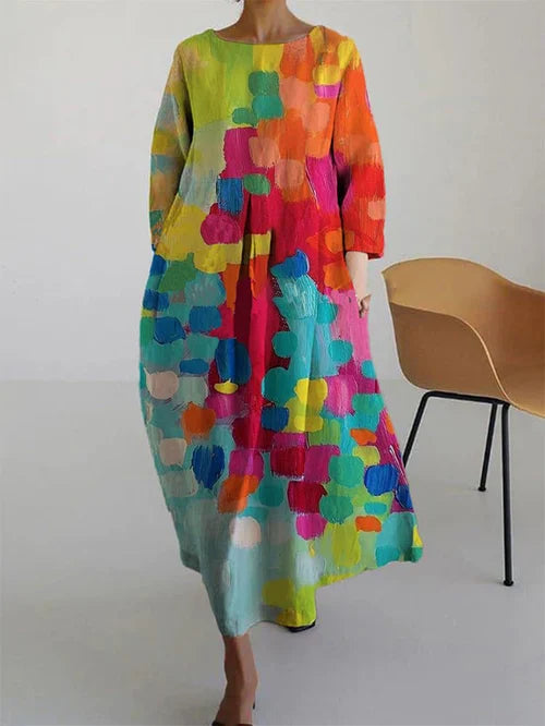 Model in abstract maxi dress, back view showing flowing silhouette