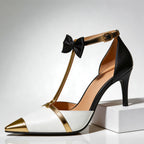 Close-up of metallic gold bow and T-strap on heel