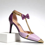 Women's lavender and purple satin T-strap heels with gold bow detail, front view