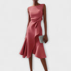 Side profile of dress showing structured bodice and cascading drape